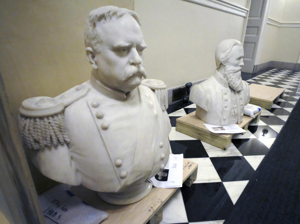 Busts of Fitzhugh Lee, left, and James E. B "Jeb" Stuart, right sit in a hallway waitng to be boxed after removal from the Old House Chamber inside the Virginia State Capitol in Richmond, Va., Thursday, July 23, 2020. (Bob Brown/Richmond Times-Dispatch via AP)