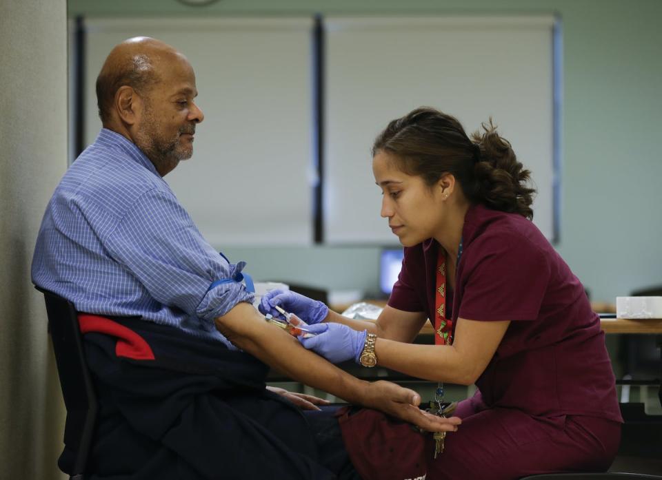Medical assistant Jennifer Martinez draws blood from Joshua Smith in Newburgh, N.Y., Nov. 3, 2016, to test for PFOS levels. PFOS had been used for years in firefighting foam at the nearby military air base, and was found in the city’s drinking water reservoir at levels exceeding federal guidelines. <a href="https://newsroom.ap.org/detail/TaintedWaterBloodTesting/bff899a063f2467f934c3ac27dd2c5f9/photo" rel="nofollow noopener" target="_blank" data-ylk="slk:AP Photo/Mike Groll;elm:context_link;itc:0;sec:content-canvas" class="link ">AP Photo/Mike Groll</a>