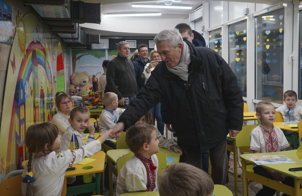 CORRECTS SPELLING OF SURNAME TO GRANDI - United Nations High Commissioner for Refugees Filippo Grandi greets pupils as he visits a school in Kharkiv, Ukraine, Monday, Jan. 22, 2024. (AP Photo/Andrii Marienko)