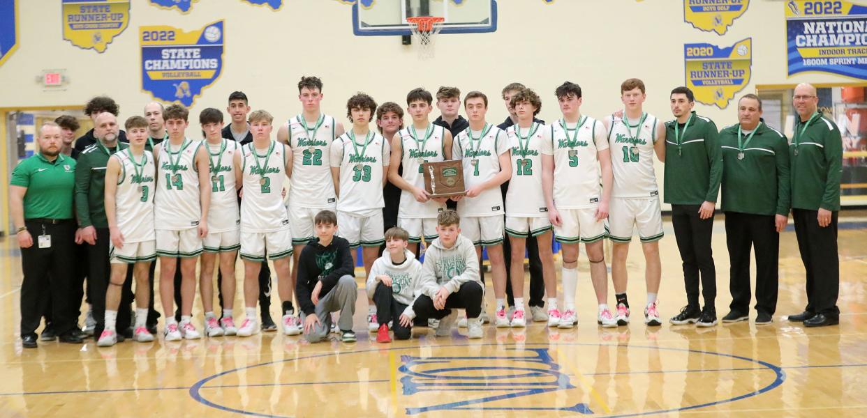 The 2023-24 West Branch boys basketball team poses for a photo with the district runner-up trophy, Saturday, March 9, 2024, at Chardon ND-CL.