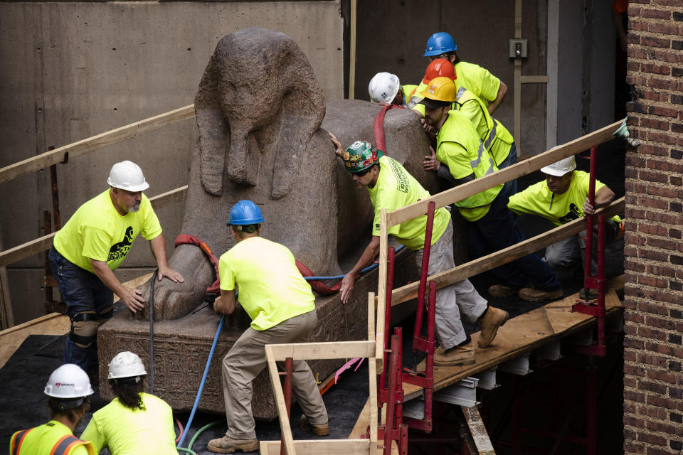 Workers move a 25,000-pound Sphinx of Ramses II at the Penn Museum in Philadelphia, Wednesday, June 12, 2019. The 3,000-year-old sphinx is being relocated from the Egypt Gallery where it's resided since 1926 to a featured location in the museum's new entrance hall. (AP Photo/Matt Rourke)