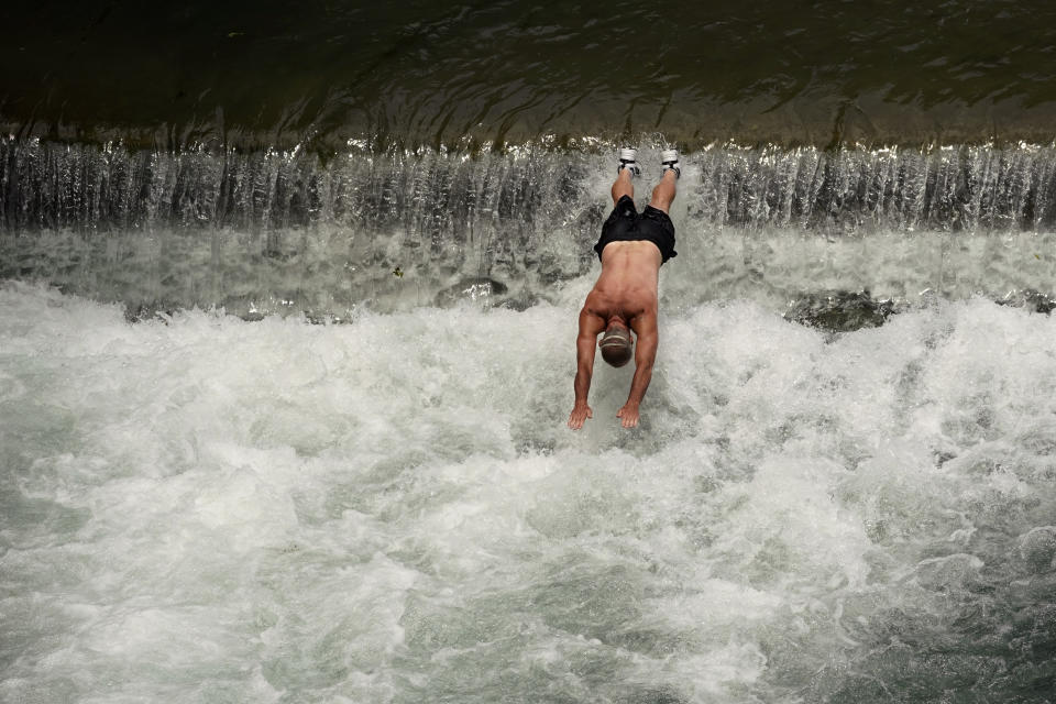 A man dives into the cool waters of the Comal River, Tuesday, June 14, 2022, in New Braunfels, Texas. (AP Photo/Eric Gay)