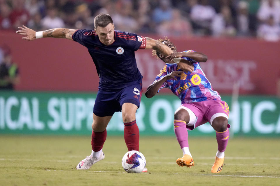 Chicago Fire defender Rafael Czichos, left, fouls Toronto FC's Latif Blessing in the second half of an MLS soccer match Saturday, July 15, 2023, in Chicago. (AP Photo/Charles Rex Arbogast)