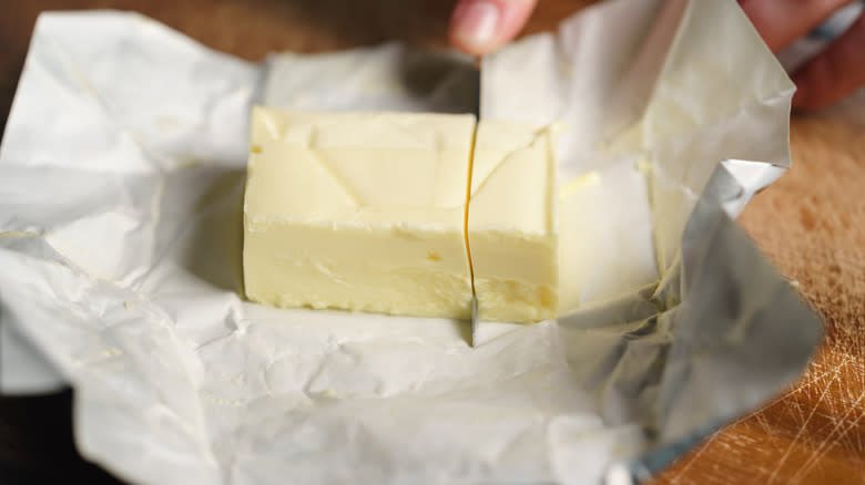 unwrapped sliced stick of butter