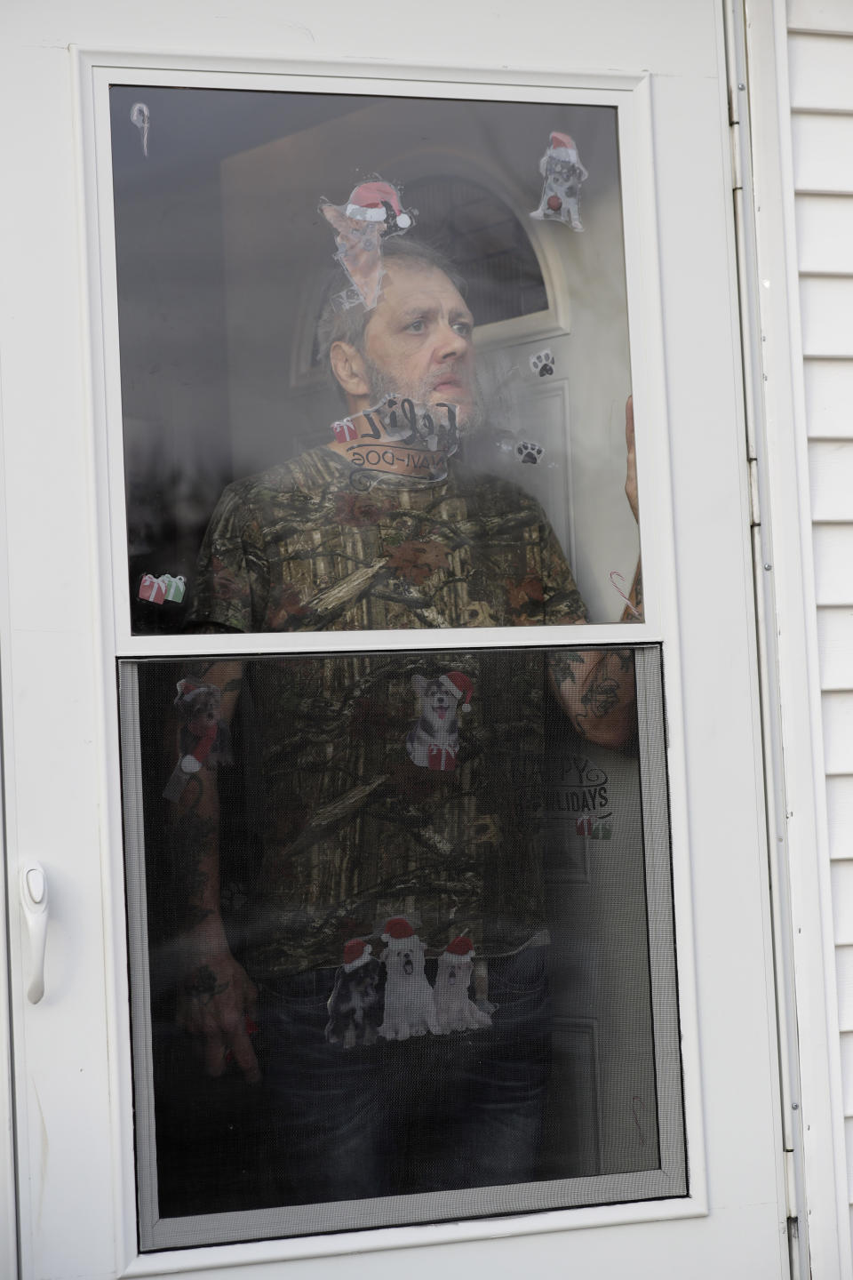 In this Friday, Dec. 20, 2019 photo, Bobby Goldberg looks outside from his home in suburban Chicago. Goldberg has filed a lawsuit claiming he was abused more than 1,000 times in multiple states and countries by the late Donald McGuire, a prominent American Jesuit priest who had close ties to Mother Teresa. (AP Photo/Nam Y. Huh)