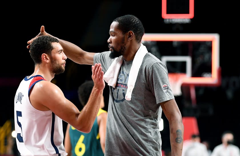-TOKYO,JAPAN August 5, 2021: USA's Kevin Durant, left, celebrates with Zach LaVine after defeating Australia in a semi-final game against Australia at the 2020 Tokyo Olympics. (Wally Skalij /Los Angeles Times)