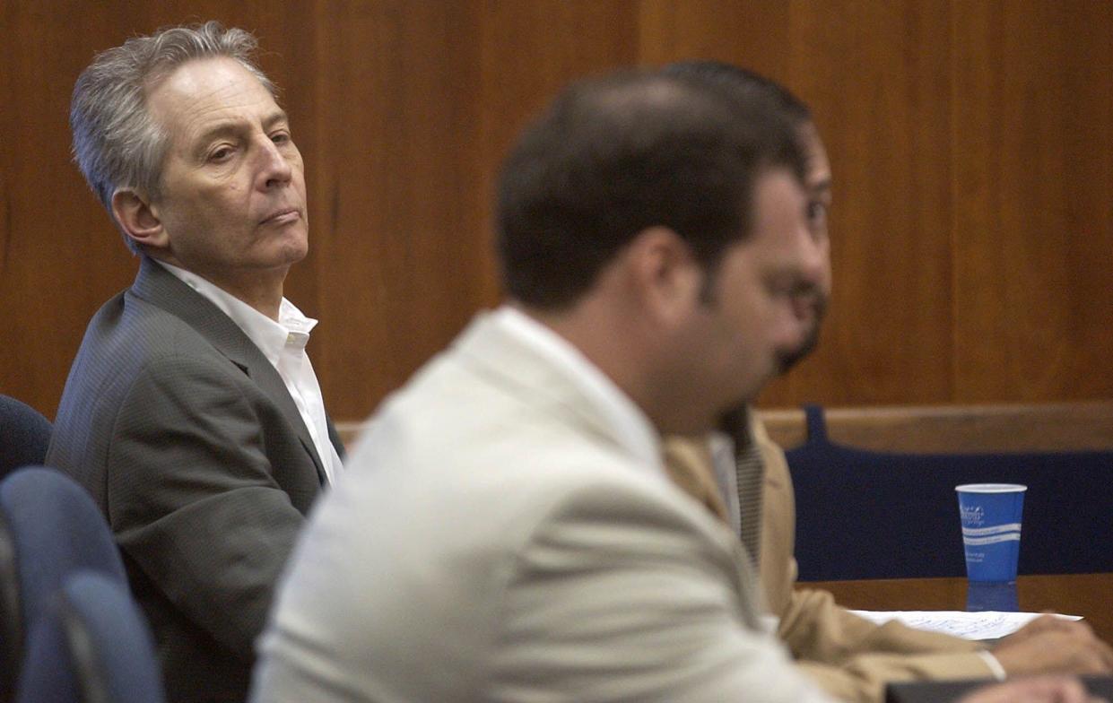 Robert Durst, left, sits in a courtroom during a pre-trial hearing at the Galveston County Courthouse in Galveston, Texas Monday, Aug. 18, 2003. Durst, 60, is a member of a wealthy real estate family from New York and faces a murder charge in the death of Morris Black, 71. Jury selection is scheduled to begin next week. (AP Photo/Kevin Bartram, POOL)