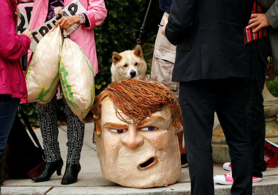 A costume head of U.S. Republican presidential candidate Donald Trump sits on the pavement as protests take place outside the Republican National Committee where Trump was meeting with Speaker of the House Paul Ryan on Capitol Hill in Washington May 12, 2016. (Kevin Lamarque/Reuters)