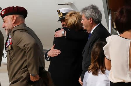 Italian sailor Salvatore Girone (2nd L) is greeted by Italian Defence minister Roberta Pinotti after landing at Ciampino airport in Rome, Italy, May 28, 2016. REUTERS/Alessandro Bianchi