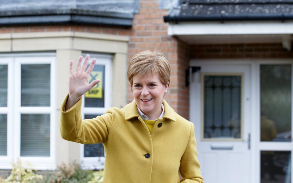 Nicola Sturgeon leaves her house at the start of polling day in Glasgow - Shutterstock