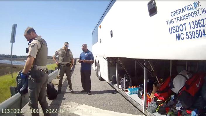 Body camera footage shows Liberty County deputies beginning their search of luggage belonging to the Delaware State University women&#39;s lacrosse team during a traffic stop on April 20, 2022, in Georgia.  The team&#39;s bus driver (middle) talks to one of the officers.