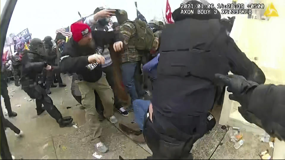 In this image from video released by the House Select Committee, the view from a police-worn body camera shows the scene on the West Front of the U.S. Capitol as rioters storm the Capitol, that the House select committee investigating the Jan. 6 attack on the U.S. Capitol showed at the hearing Monday, June 13, 2022, on Capitol Hill in Washington. (House Select Committee via AP)