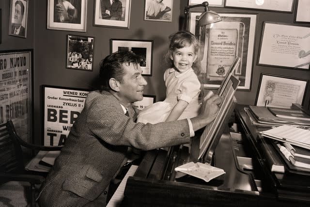 <p>Bettmann Archive/Getty</p> Leonard Bernstein with daughter Jamie, c. 1950s.