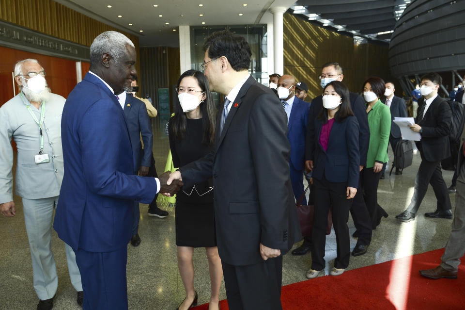 China's Foreign Minister, Qin Gang, center, shakes hands with African Union Commission (AUC) chair Moussa Faki Mahamat as he arrives at the African Union headquarters in Addis Ababa, Ethiopia, Wednesday, Jan. 11, 2023. Qin has begun a five-nation tour of Africa aimed at bolstering Chinese-African ties. (AP Photo)