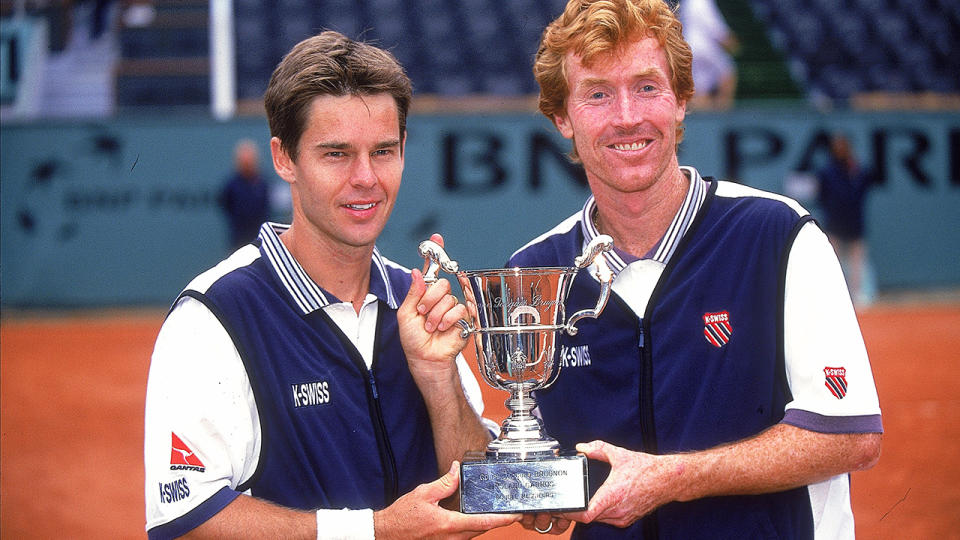 Todd Woodbridge and Mark Woodforde are pictured with the men's doubles trophy after their French Open win in 2000.