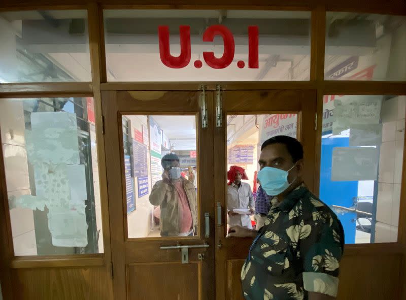 A private security guard stands at the entrance of the intensive care unit of the Jawaharlal Nehru Medical College and Hospital in Bhagalpur district in Bhagalpur