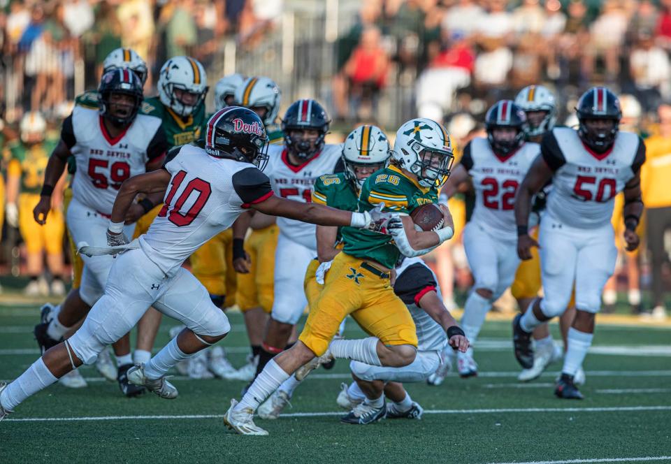 St. Xavier's Adam Boone breaks eludes a tackler as he leads his team on a touchdown drive against Owensboro. Aug. 19, 2022