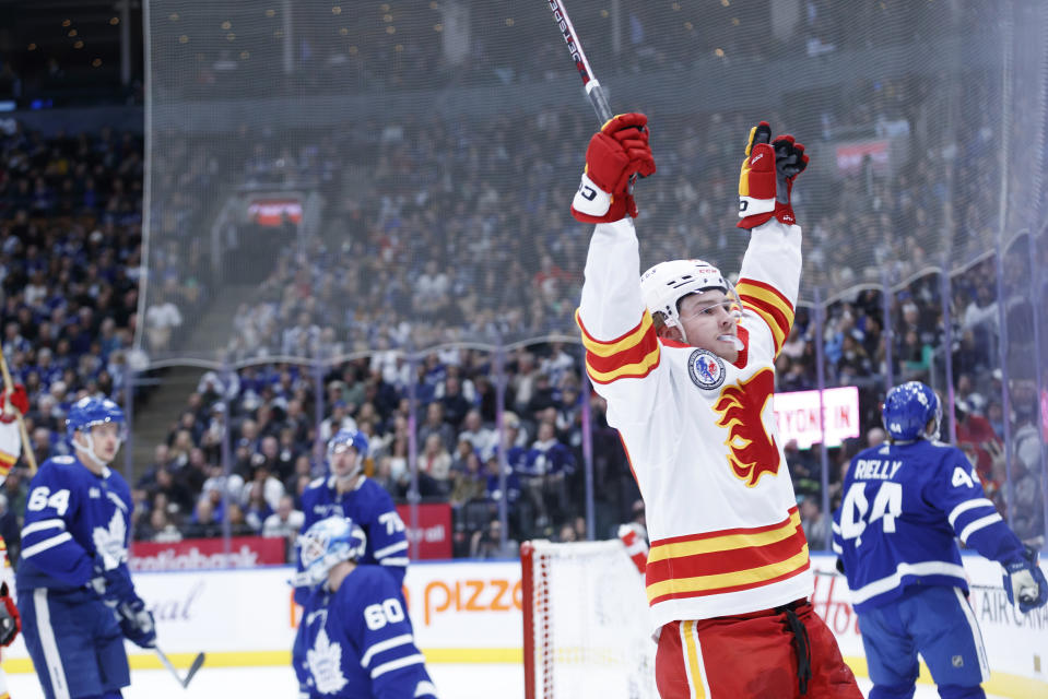 Calgary Flames centre Connor Zary (47) celebrates his goal against the Toronto Maple Leafs during the first period of an NHL hockey game Friday, Nov. 10, 2023, in Toronto. (Cole Burston/The Canadian Press via AP)