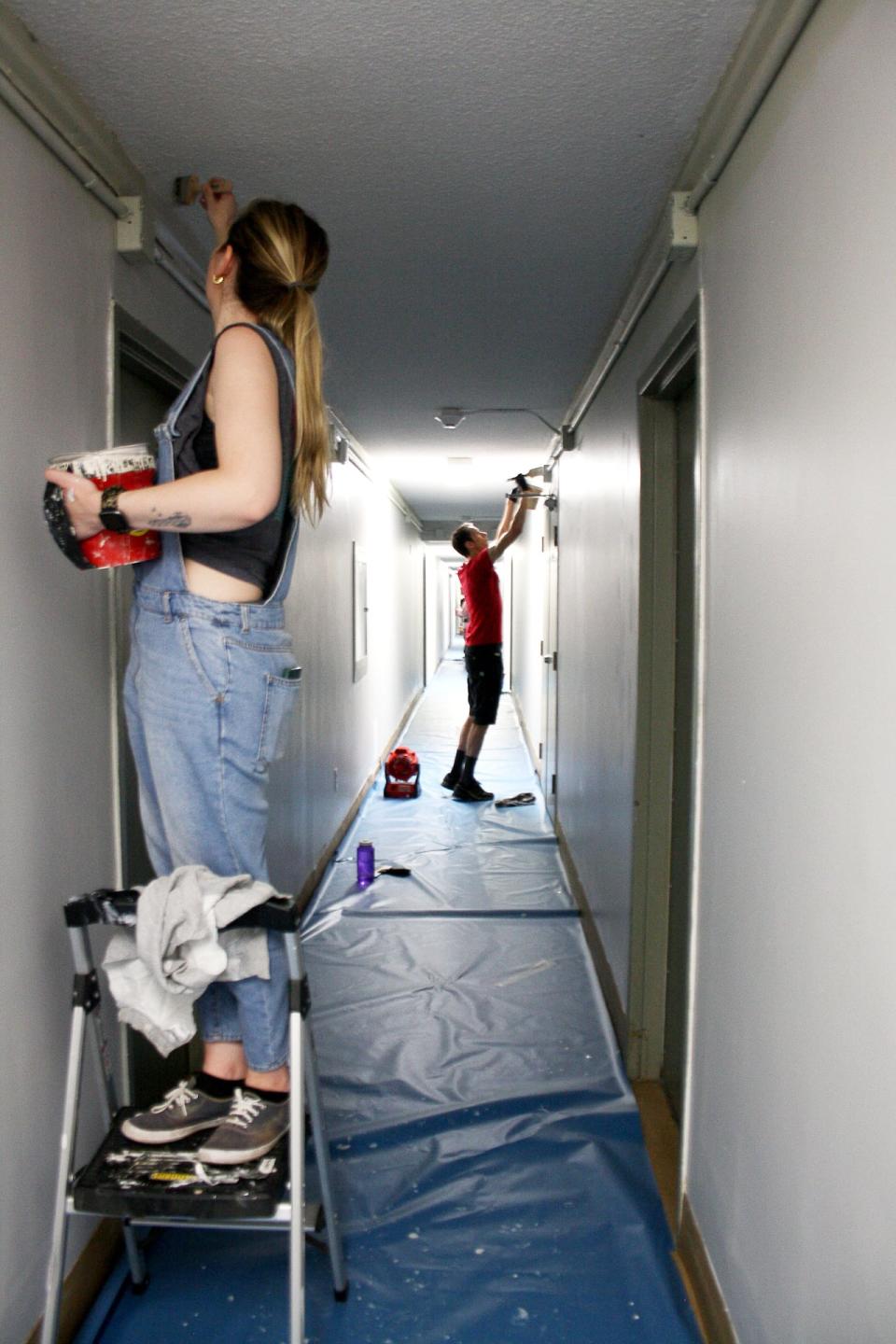 Volunteers paint the walls of an apartment building. Despite the wide range of volunteering opportunities available, it can still be challenging to find enough people wanting to help, Volunteer Ottawa's executive director says. 