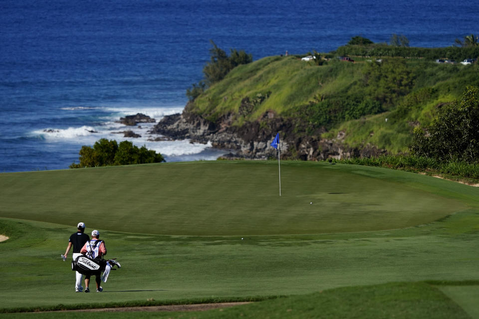 Sungjae Im, of South Korea, walks down the 11th fairway with his caddy during the second round of the Tournament of Champions golf event, Friday, Jan. 7, 2022, at Kapalua Plantation Course in Kapalua, Hawaii. (AP Photo/Matt York)