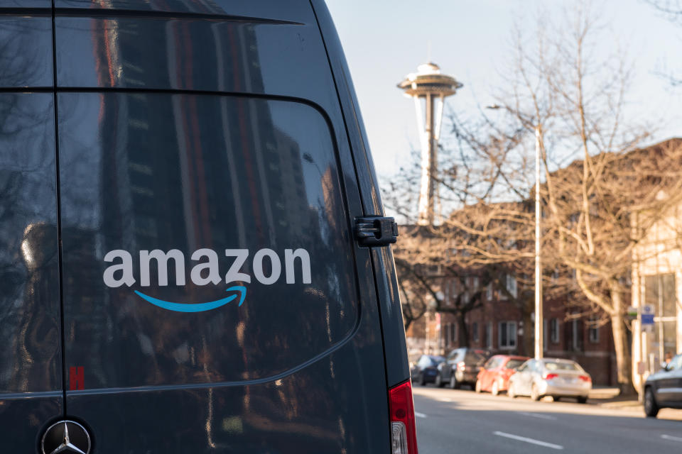 Seattle, USA - Feb 10, 2020: Amazon Prime Now Delivery van on 4th avenue late in the day with the Space Needle in the background.