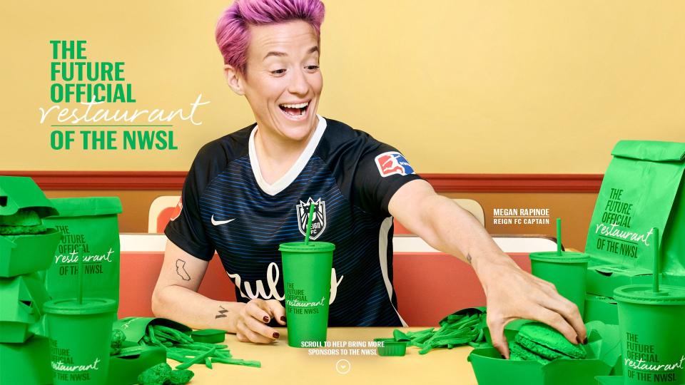 Megan Rapinoe consumes fast food and and sports a watch as part of Budweiser's tongue-in-cheek ad campaign promoting the NWSL. (Via Budweiser)