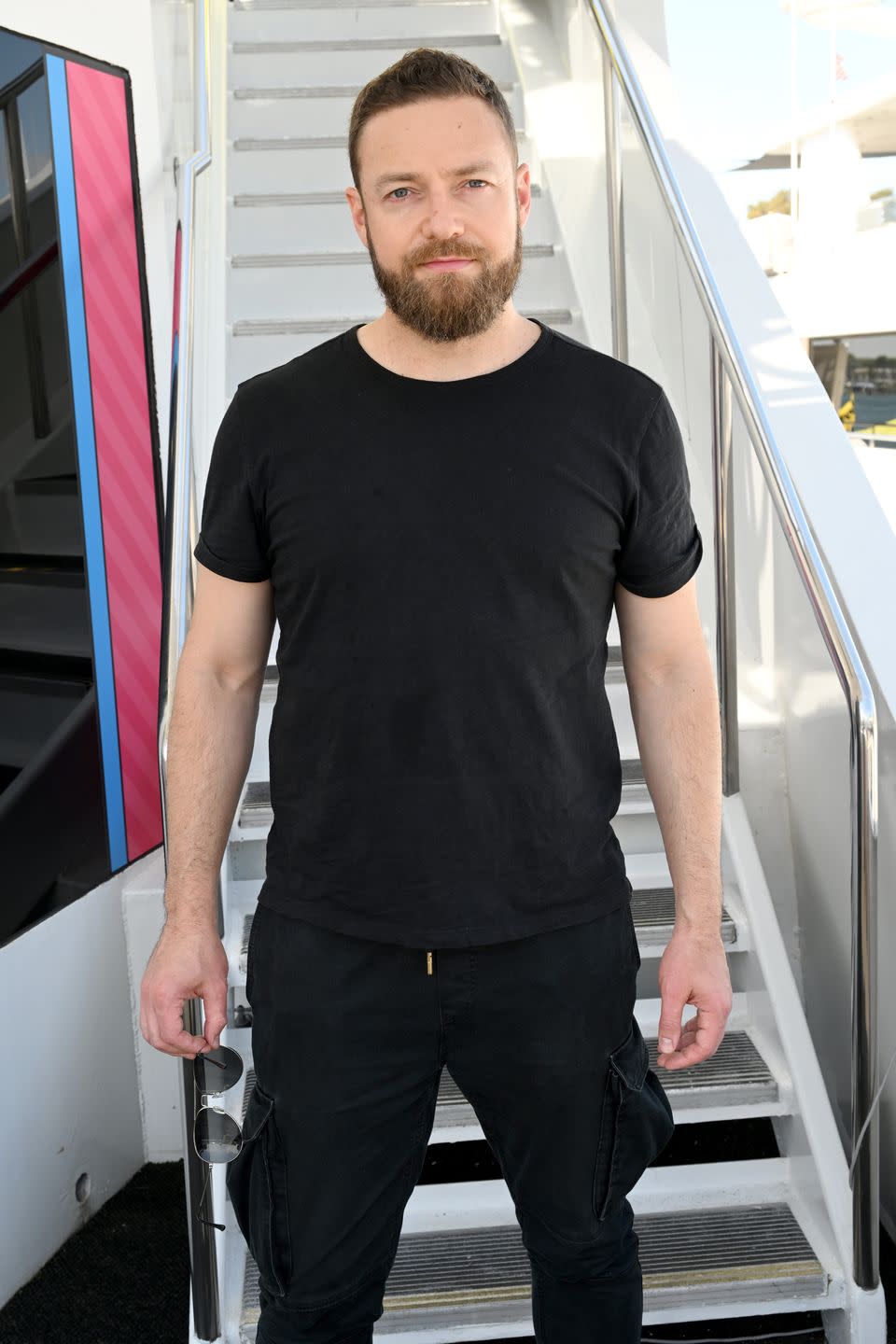 ross marquand standing next to stairs