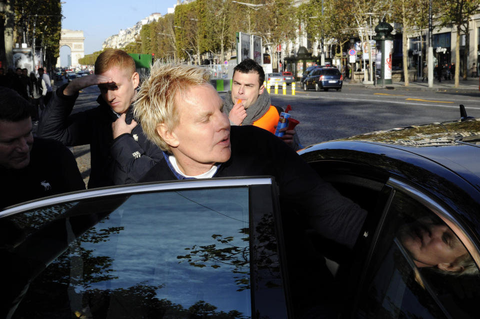 Mike Jeffries, ex-CEO of clothing retailer Abercrombie & Fitch, leaves the store on the Champs Elysees avenue in Paris on October 27, 2012. / Credit: BERTRAND GUAY/AFP via Getty Images