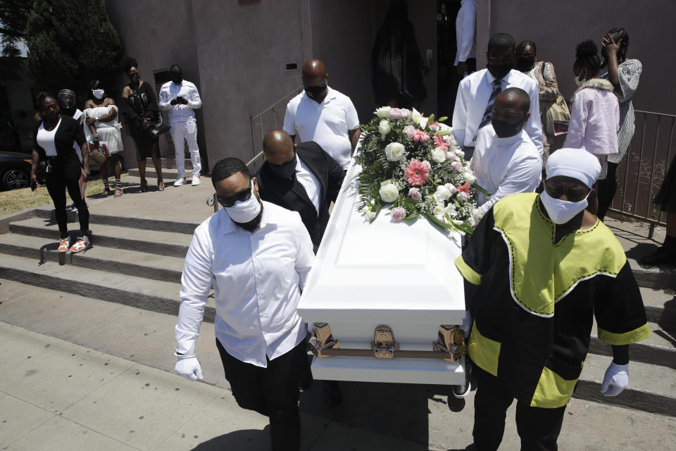 FILE - In this July 21, 2020 file photo Pall bearers carry a casket with the body of Lydia Nunez, who died from COVID-19, after a funeral service at the Metropolitan Baptist Church, in Los Angeles. Southern California funeral homes are turning away bereaved families because they're running out of space for the bodies piling up during an unrelenting coronavirus surge. (AP Photo/Marcio Jose Sanchez,File)