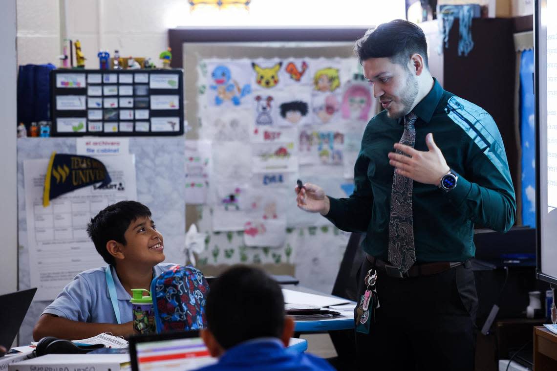 Agustin Tiliano talks to a student during his fifth-grade bilingual class at the Leadership Academy at Mitchell Boulevard Elementary.