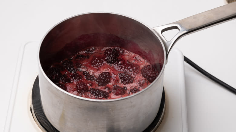 cooking blackberry glaze in saucepan