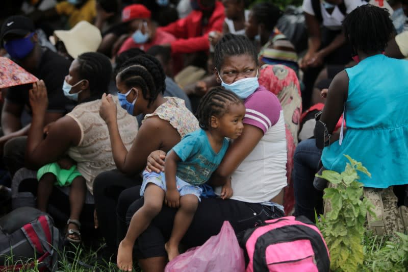 African, Cuban and Haitian migrants, which are stranded in Honduras after borders were closed due to the coronavirus disease (COVID-19) outbreak, rest while trekking northward in an attempt to reach the United States, in Choluteca