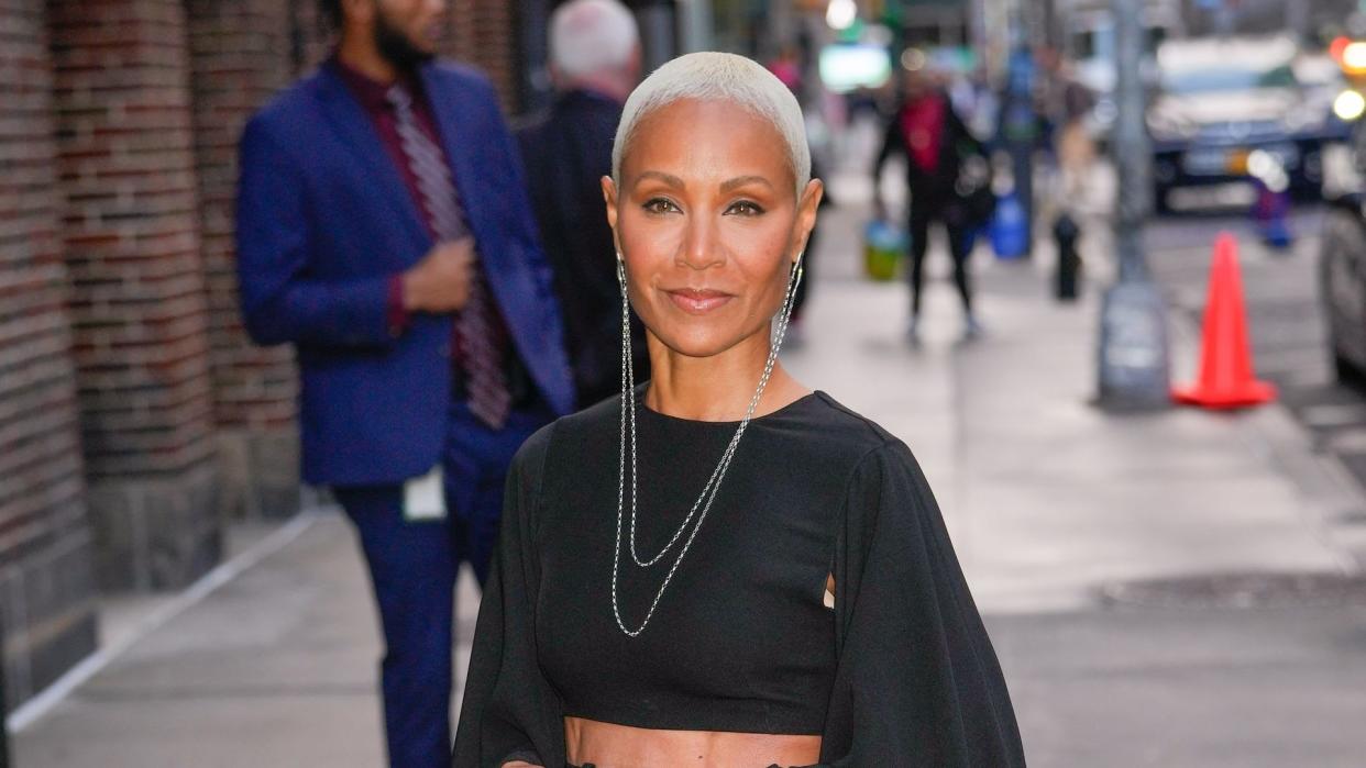 Jada Pinkett Smith smiling in a black crop top 