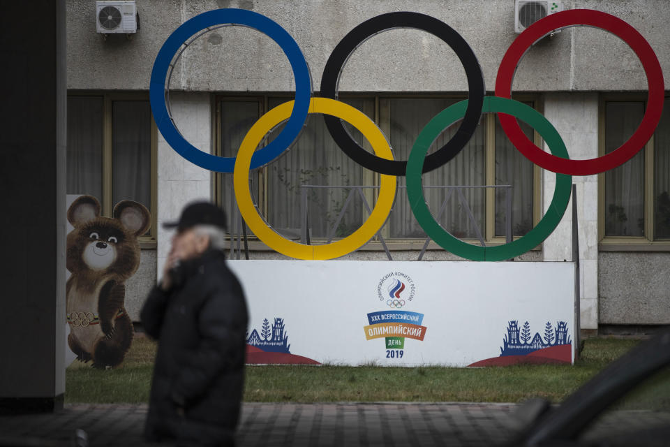 FILE - In this Nov. 28, 2019 file photo Olympic Rings and a model of Misha the Bear Cub, the mascot of the Moscow 1980 Olympic Games, left, are seen in the yard of Russian Olympic Committee building in Moscow, Russia. Russia was banned Thursday Dec. 17, 2020 from using its name, flag and anthem at the next two Olympics or at any world championships for the next two years. The Court of Arbitration for Sport's ruling also blocked Russia from bidding to host major sporting events for two years. (AP Photo/Pavel Golovkin, file)