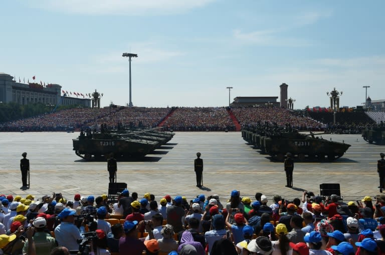 Military vehicles roll through Beijing's Tiananmen Square during a military parade to mark the 70th anniversary of Japan's WWII defeat