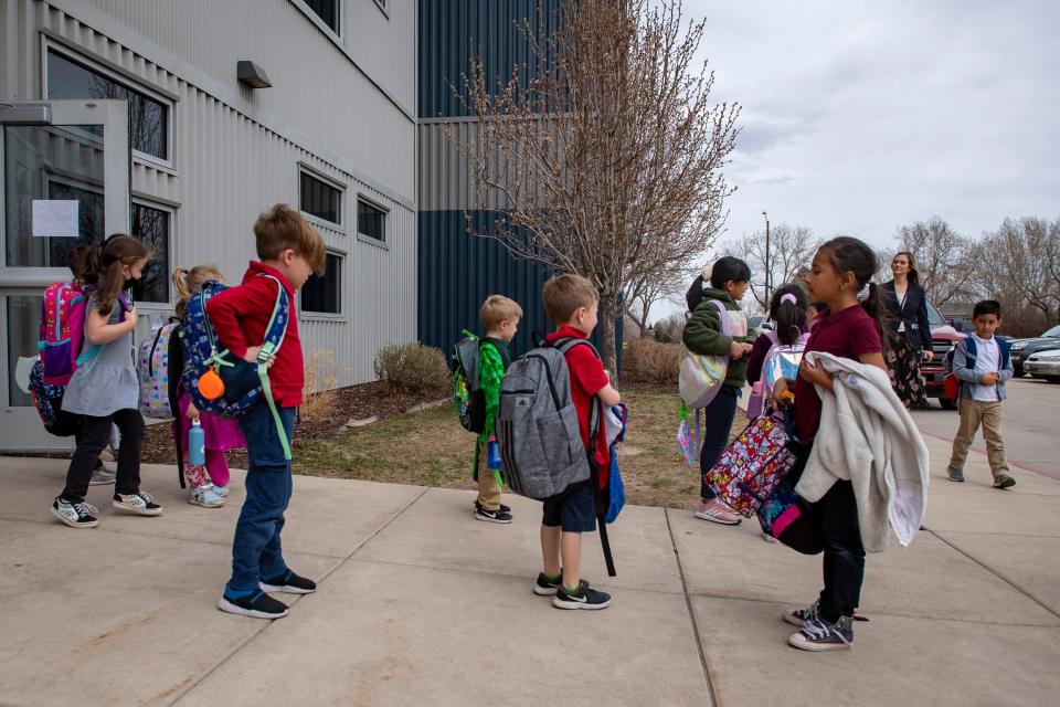 AXIS International Academy students wait for their rides after school in Fort Collins, Colorado, on Tuesday, April 19, 2022.