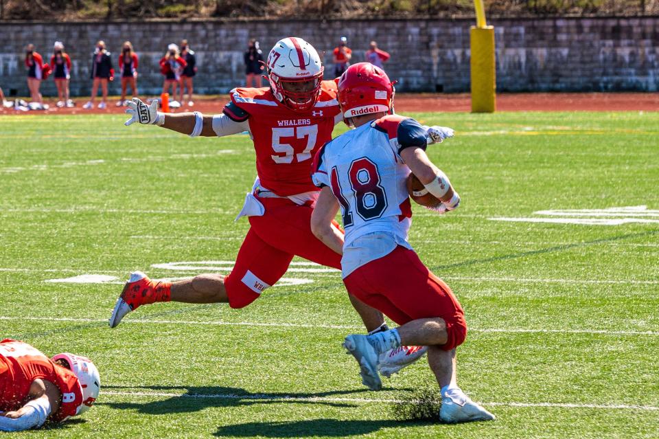 New Bedford's Bill Sousa looks to wrap up Bridgewater-Raynham's Anthony Morrison.