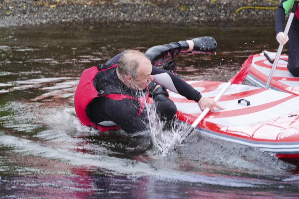 Britain's Liberal Democrat Leader Ed Davey falls into the water while paddleboarding on Lake Windermere, in Windermere, England, Tuesday, May 28, 2024, while on the general election campaign trail. (Peter Byrne/PA via AP)