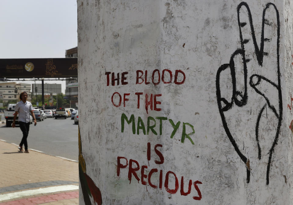 A quote from the Sudanese opposition is seen on a wall Sunday, June 16, 2019, about the protesters who were killed by security forces on June 3, 2019, where demonstrators had been holding a sit-in, in Khartoum, Sudan. Sudanese officials say al-Bashir is being taken to the prosecutor's office for corruption probe. (AP Photo/Hussein Malla)