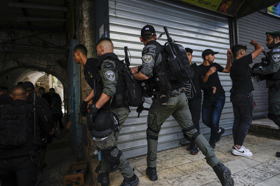 Israeli police push away Palestinians from a street in the Muslim Quarter of Jerusalem's Old City, shortly before a march through the area by Jewish nationalists, Thursday, May 18, 2023. The parade was marking Jerusalem Day, an Israeli holiday celebrating the capture of east Jerusalem in the 1967 Mideast war. Palestinians see the march as a provocation. (AP Photo/Ohad Zwigenberg)