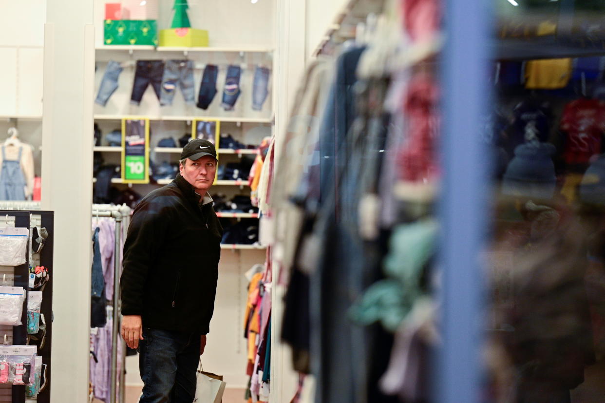 A shopper browses through clothing in a store as Black Friday sales begin at The Outlet Shoppes of the Bluegrass in Simpsonville, Kentucky, U.S. November 26, 2021.  REUTERS/Jon Cherry