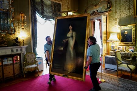 Workers carry "The Marquise of Lazan" painting by the Spanish painter Francisco Goya at Liria Palace in Madrid