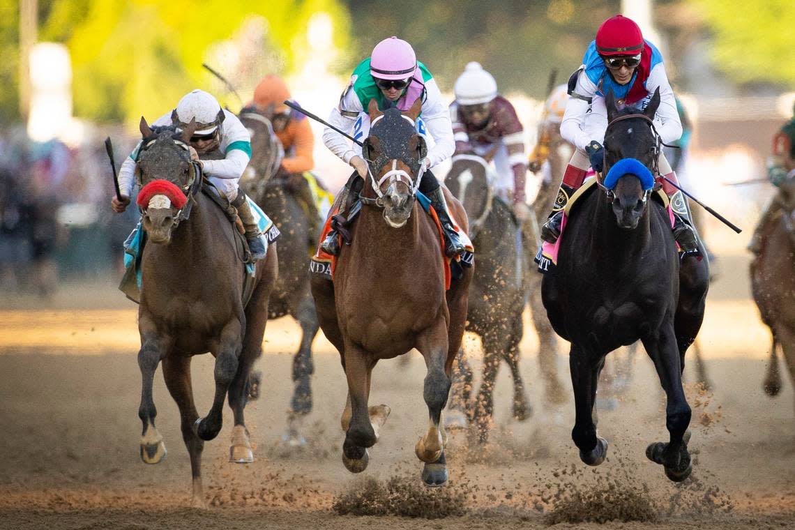 Mandaloun with Florent Geroux up, center, crosses the finish line behind Medina Spirit, right, during the 147th running of the Kentucky Derby in 2021. Mandaloun was later declared the winner after Medina Spirit failed a postrace drug test.
