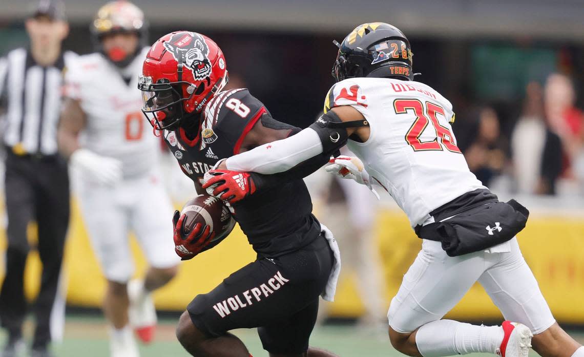 N.C. State wide receiver Julian Gray (8) looks to get by Maryland defensive back Gavin Gibson (26) during the first half of N.C. State’s game against Maryland in the Duke’s Mayo Bowl at Bank of America Stadium in Charlotte, N.C., Friday, Dec. 30, 2022.