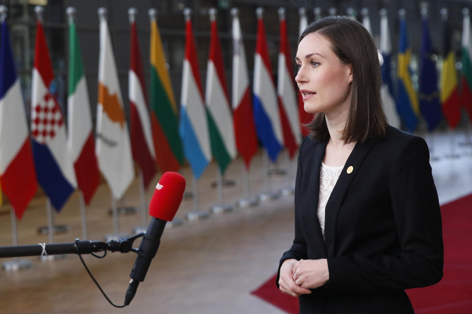 Finland's Prime Minister Sanna Marin talks to journalists as she arrives for an EU summit in Brussels, Friday, Oct. 22, 2021. European Union leaders conclude a two-day summit on Friday in which they discuss issues such as climate change, the energy crisis, COVID-19 developments and migration. (Johanna Geron, Pool Photo via AP)