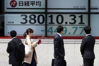 People look at an electronic stock board showing Japan's Nikkei 225 index at a securities firm Thursday, April 25, 2024, in Tokyo. (AP Photo/Eugene Hoshiko)