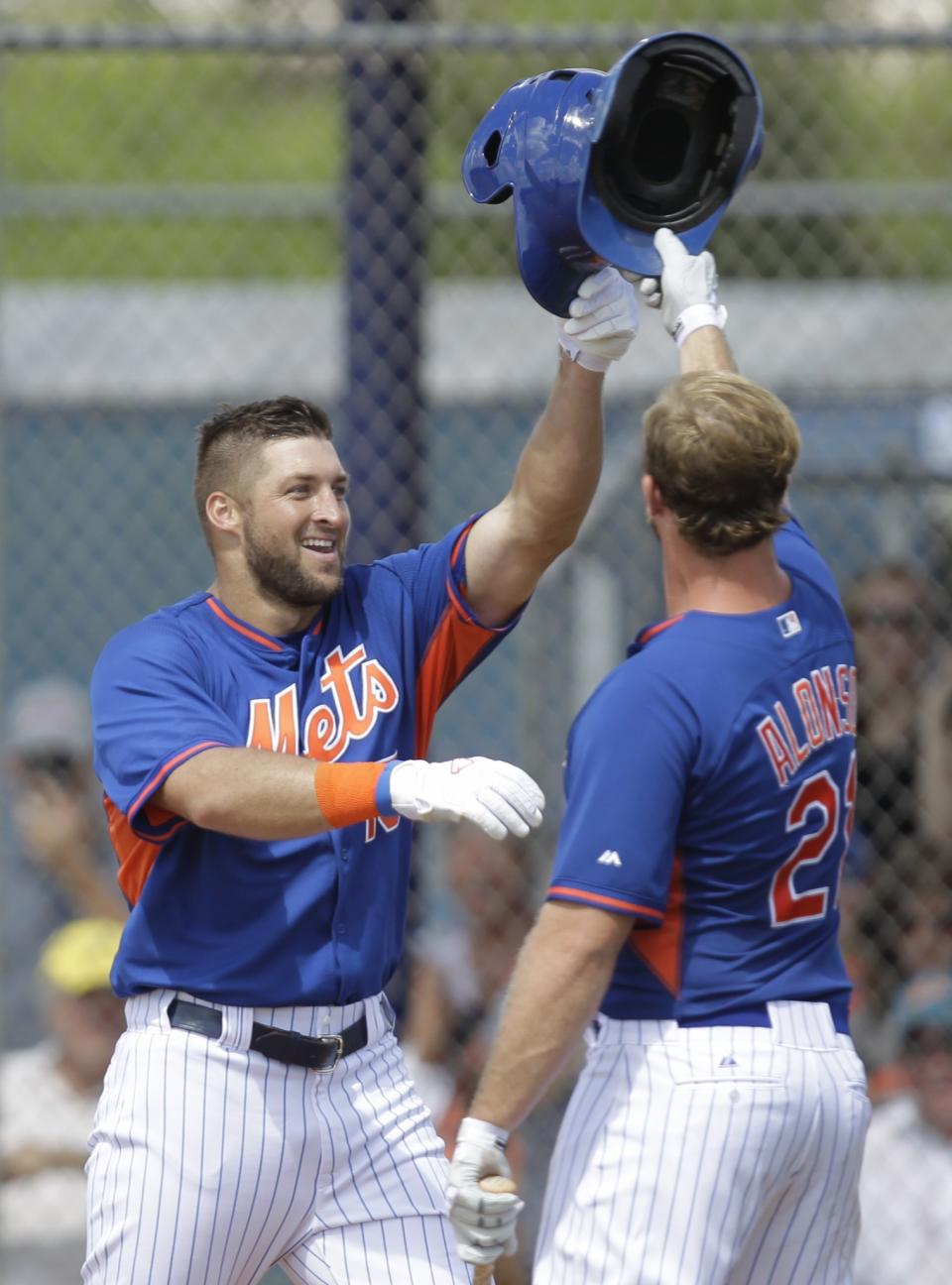 <p>Tim Tebow is greeted by Peter Alonso after hitting a solo home run in his first at bat during the first inning of his first instructional league baseball game for the New York Mets against the St. Louis Cardinals instructional club Wednesday, Sept. 28, 2016, in Port St. Lucie, Fla. (AP Photo/Luis M. Alvarez) </p>