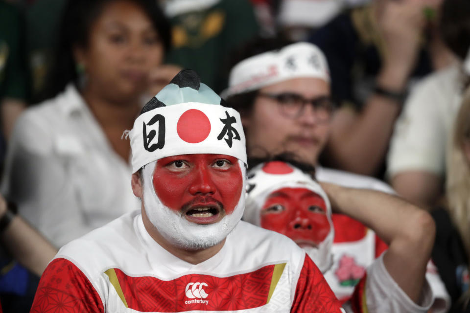Fans react during the Rugby World Cup quarterfinal match at Tokyo Stadium between Japan and South Africa in Tokyo, Japan, Sunday, Oct. 20, 2019. (AP Photo/Jae C. Hong)