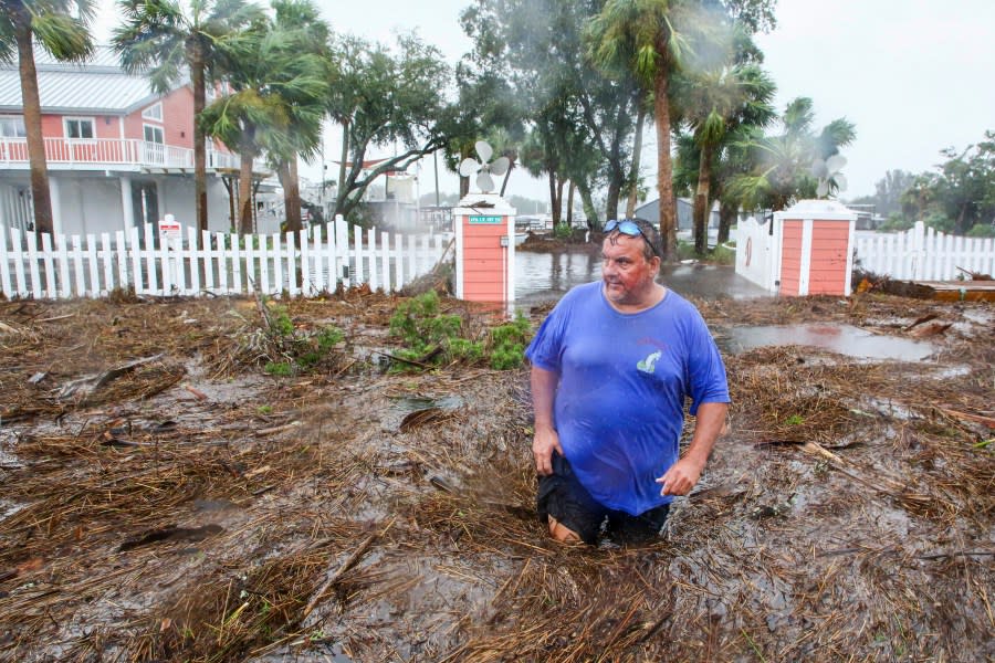 Daniel Dickert wades through water in front of his home where the Steinhatchee River overflowed on Wednesday, Aug. 30, 2023, in Steinhatchee, Fla., after the arrival of Hurricane Idalia. (Douglas R. Clifford/Tampa Bay Times via AP)