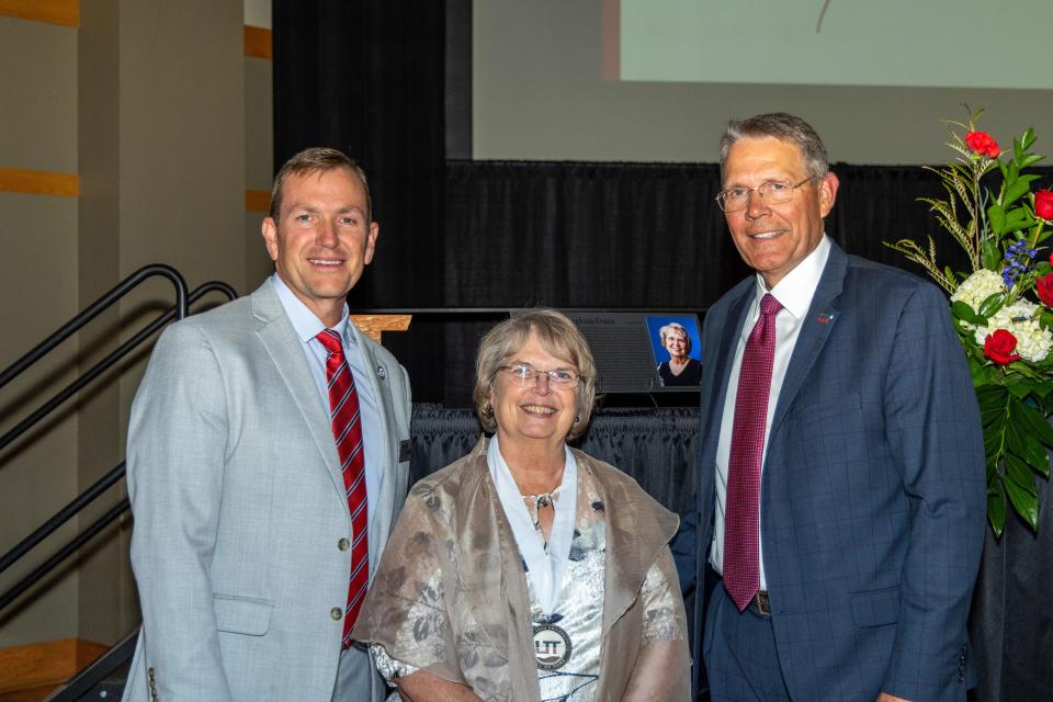 Donna Dillingham-Evans, a new inductee into the Utah Tech University Hall of Fame, is flanked by UT President Biff Williams (left) and Brad Last, UT's vice president of University Advancement.